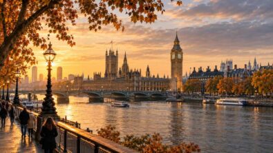 Autumn trees frame the River Thames, Big Ben and the Palace of Westminster in golden light